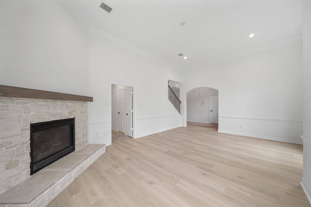 The living room features a stunning stone fireplace that adds warmth and character to the room.