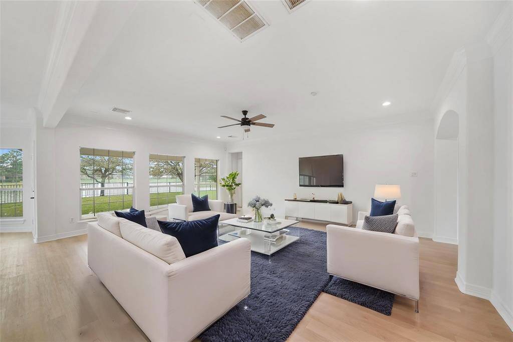A stunning wall of windows floods the space with natural light, creating a bright and inviting atmosphere.