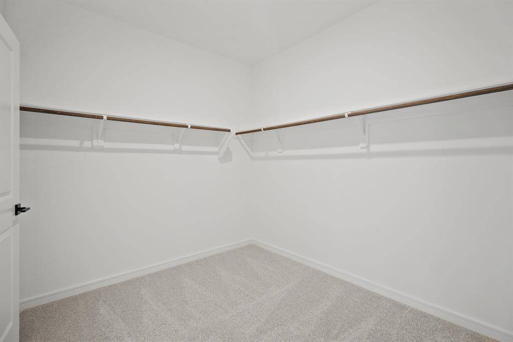 Walk-in closet in primary suite (*Photo not of actual home and used for illustration purposes only.)
