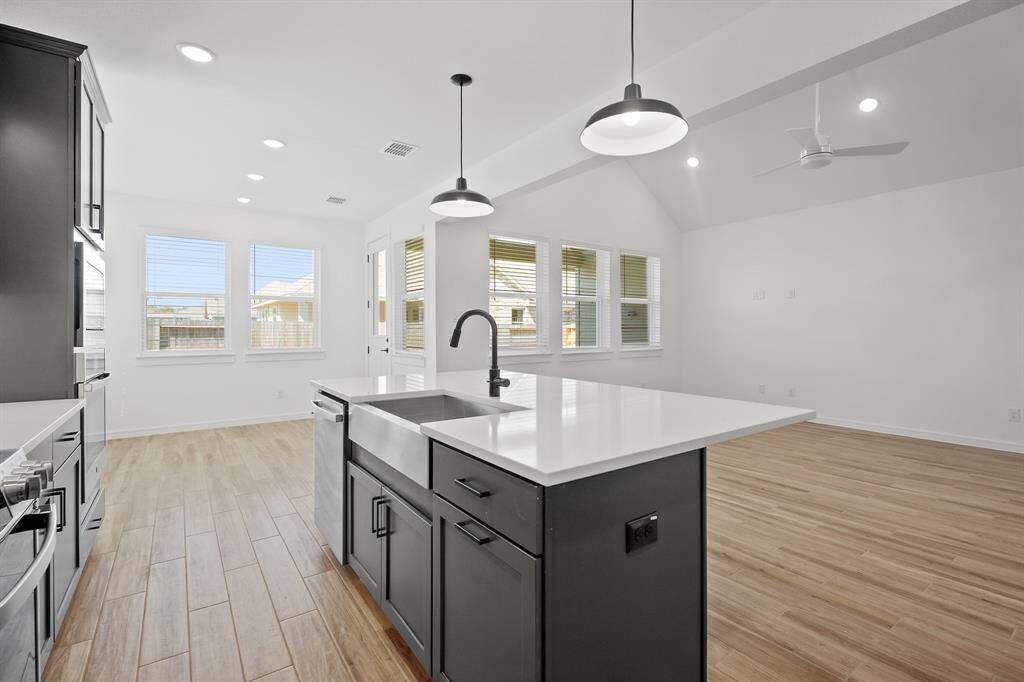 Island kitchen open to the great room (*Photo not of actual home and used for illustration purposes only.)