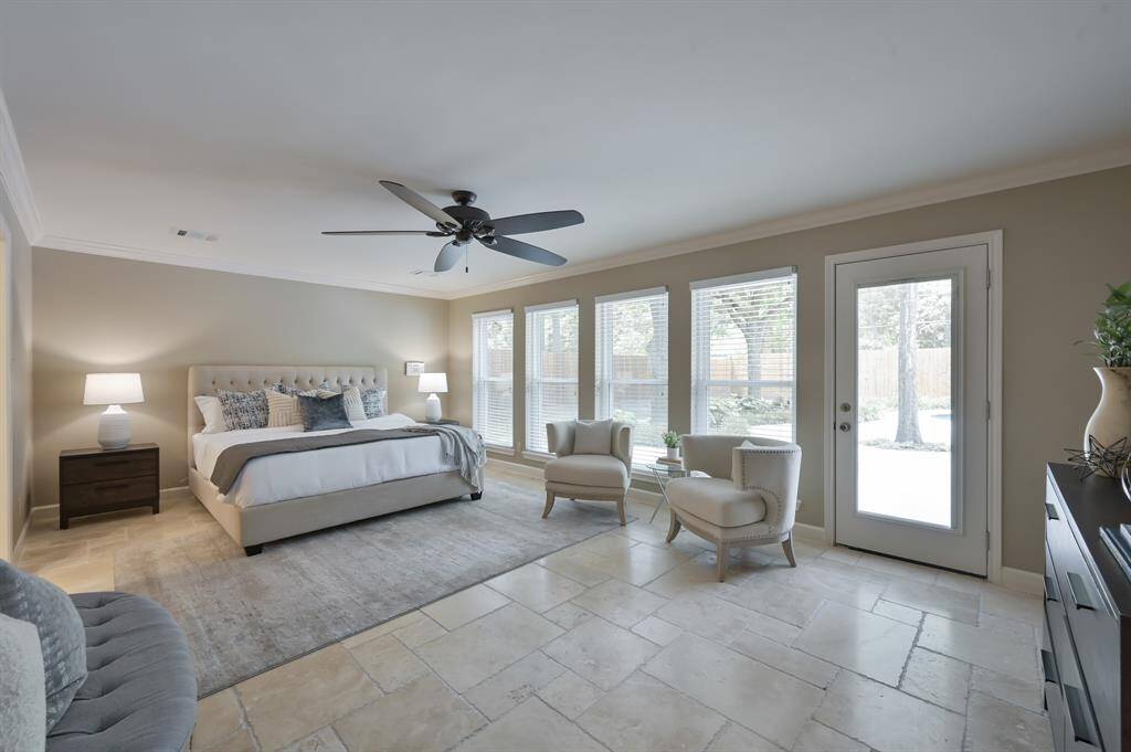 Primary bedroom with perfect views of the backyard. Notice the travertine flooring!
