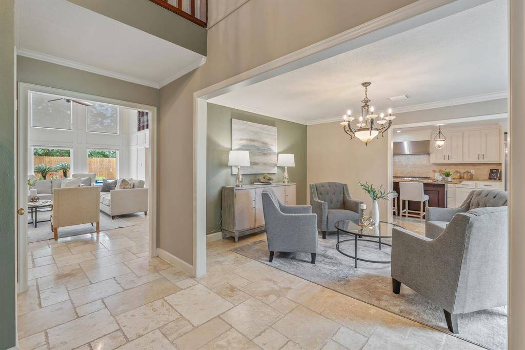 When you step in you're welcomed with travertine flooring throughout the first level of this beauty!