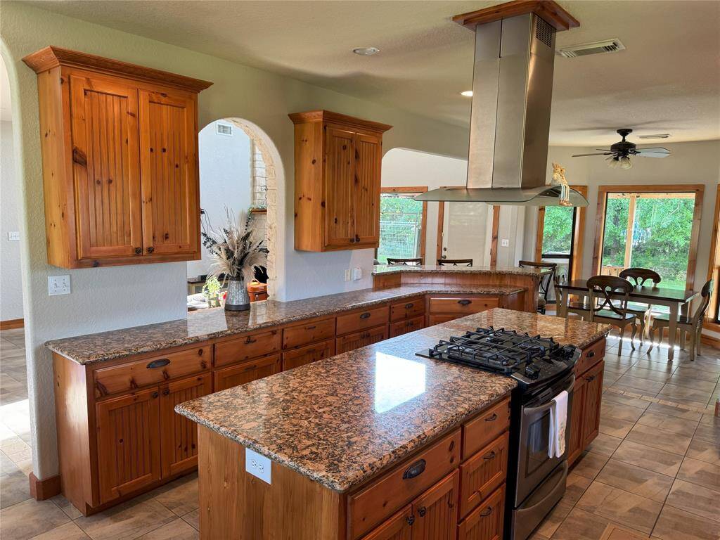 The Kitchen sees into the breakfast nook with beautiful natural views in the backyard.
