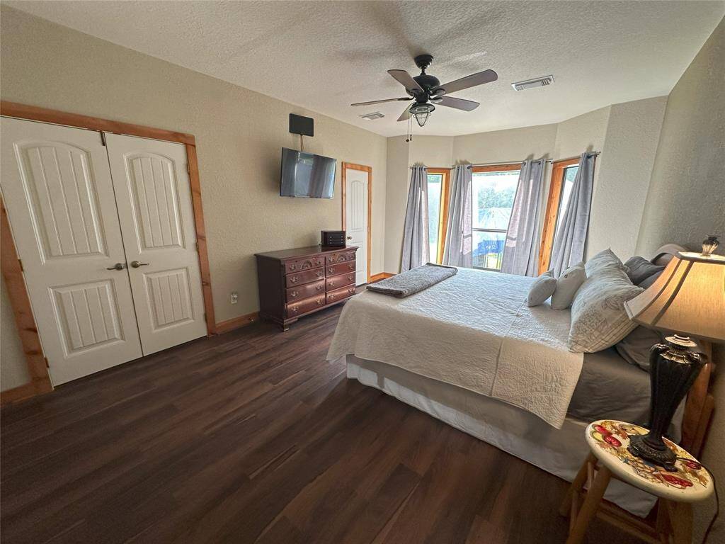 The primary bedroom offers a spacious getaway with bay windows that look into the large backyard where deer frequent.