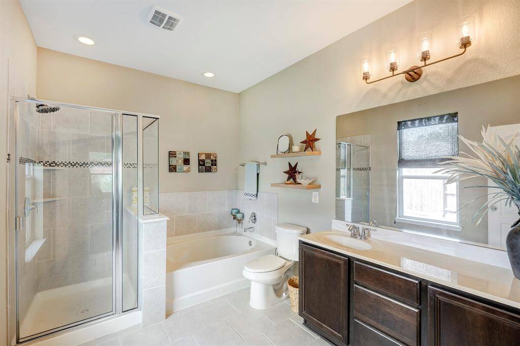 Primary bath with separate soaking tub. Not pictured, a large walk-in closet.