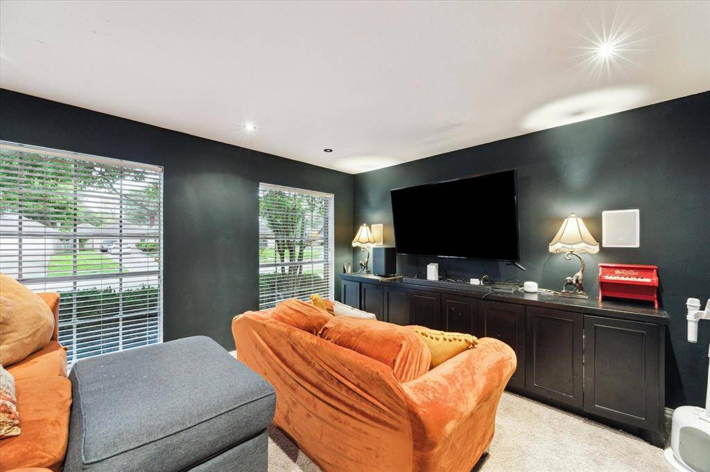 The media room is located to the left of the entry behind frosted media room doors and features a built-in entertainment center, is wired for sound and a projector, and includes raised seating.