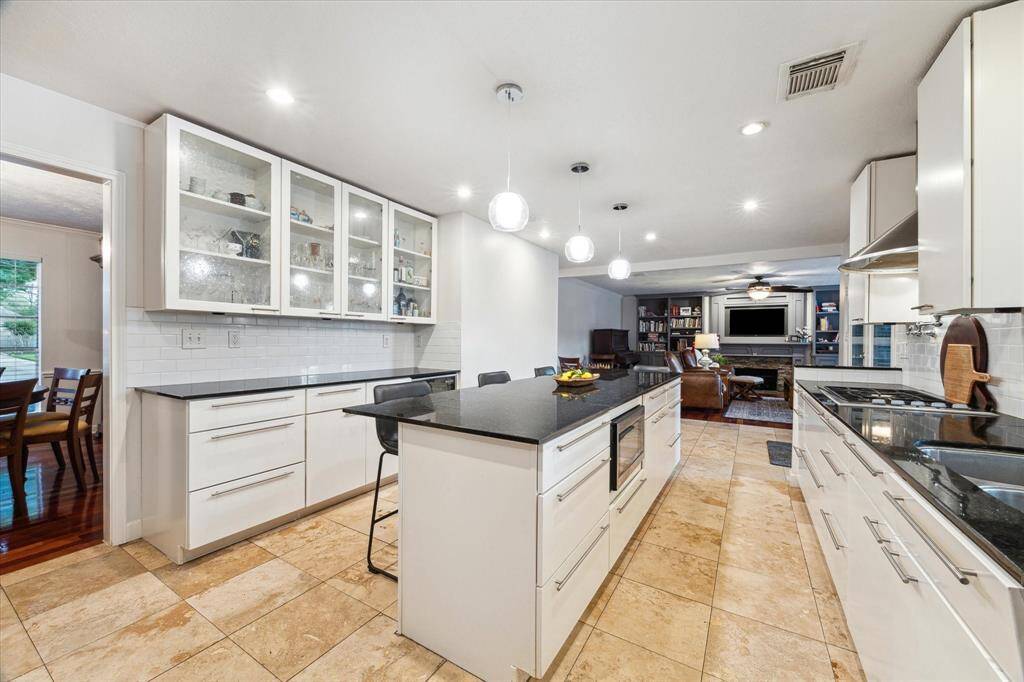 This incredible chef's kitchen is SO BEAUTIFUL AND FUNCTIONAL and open to the family room! Soft close cabinetry includes drawers galore and glass door cabinets for your lovelies.