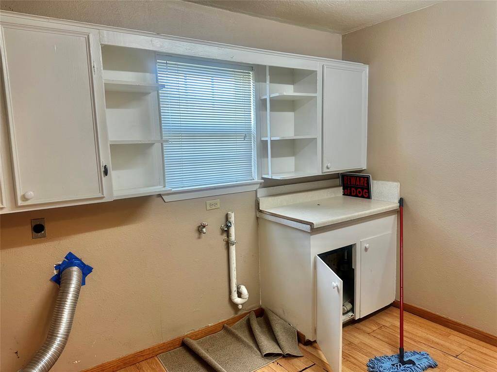 Utility room. Electric dryer. Lots of storage.