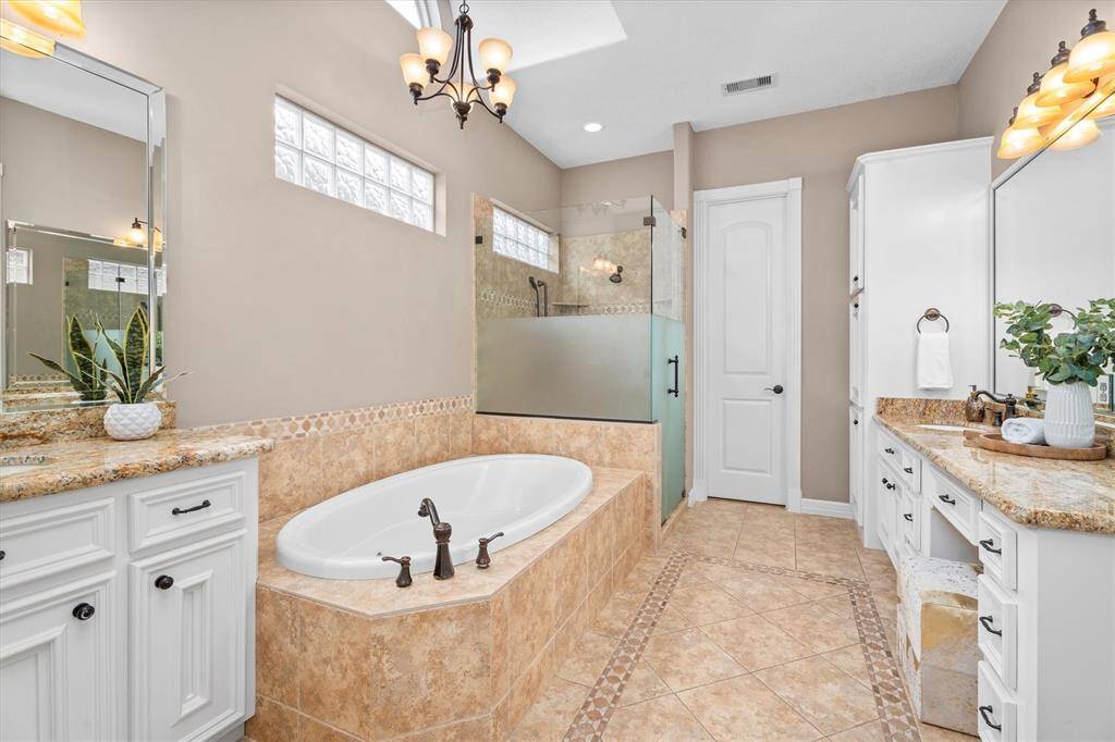 Primary bathroom with his and her closets