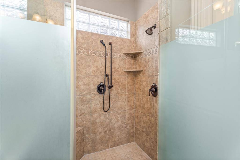 Tiled shower with glass enclosure