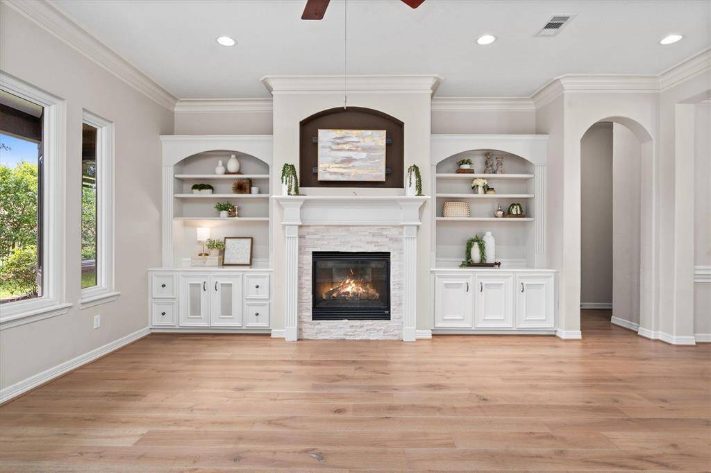 Gas fireplace flanked by built-ins and wired for surround sound
