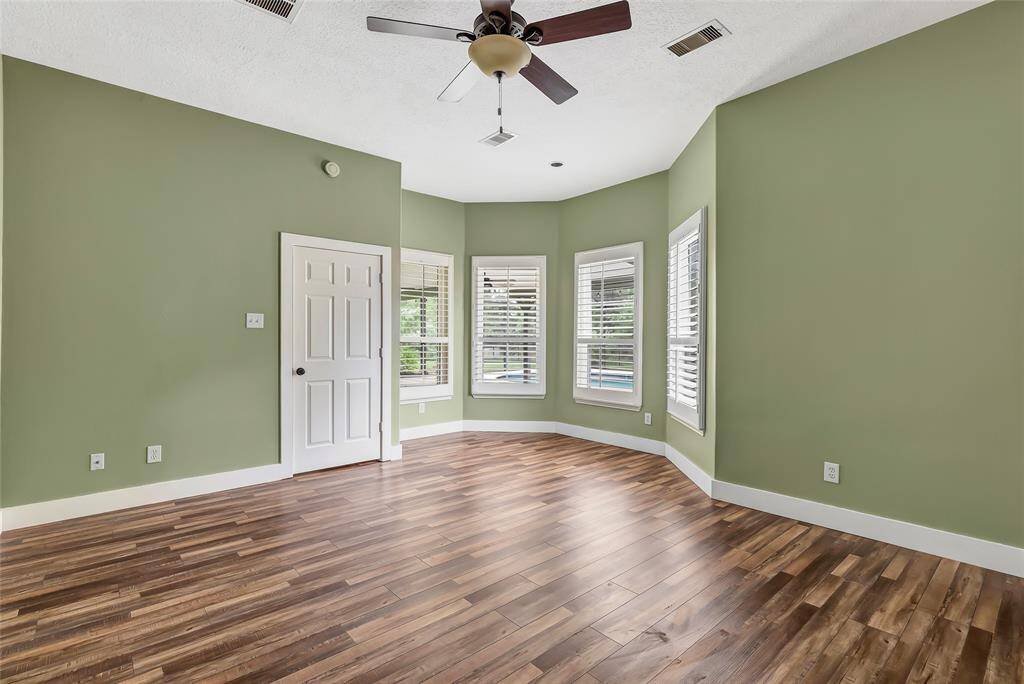 Unwind in this spacious and beautifully appointed primary suite, featuring soaring high ceilings and a sitting area that add an airy, luxurious feel.