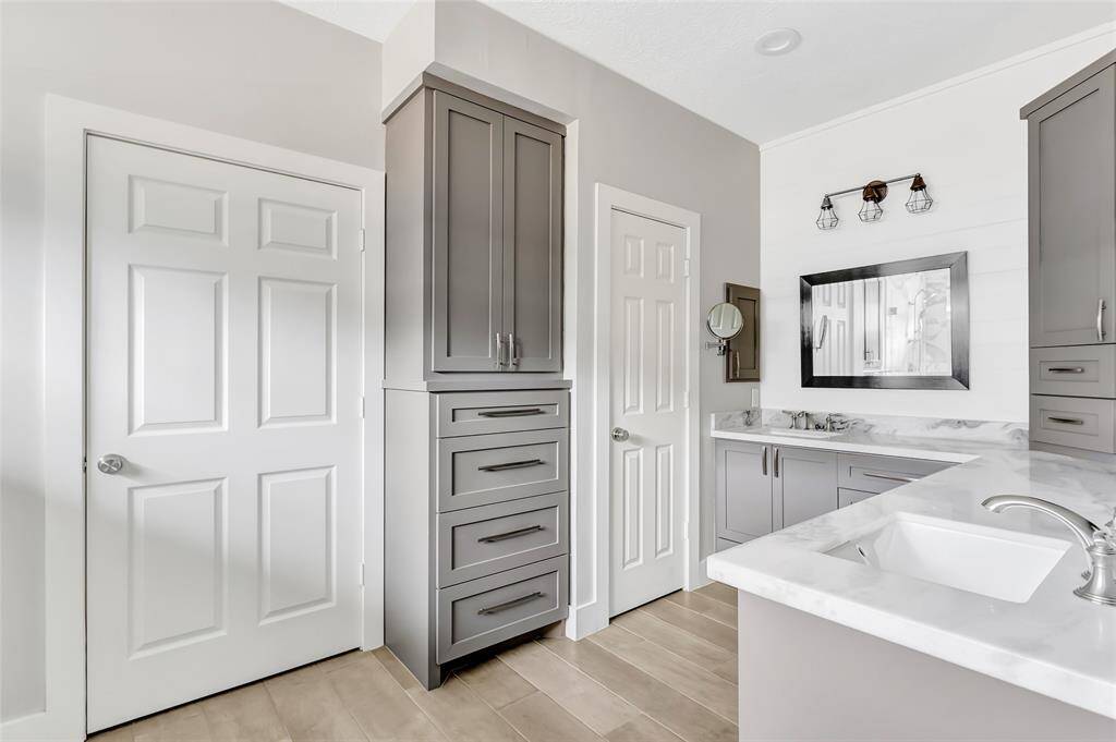 Step into a spa-like escape in this beautifully designed primary bathroom, featuring dual shower heads in a spacious walk-in shower for the ultimate in comfort and convenience.
