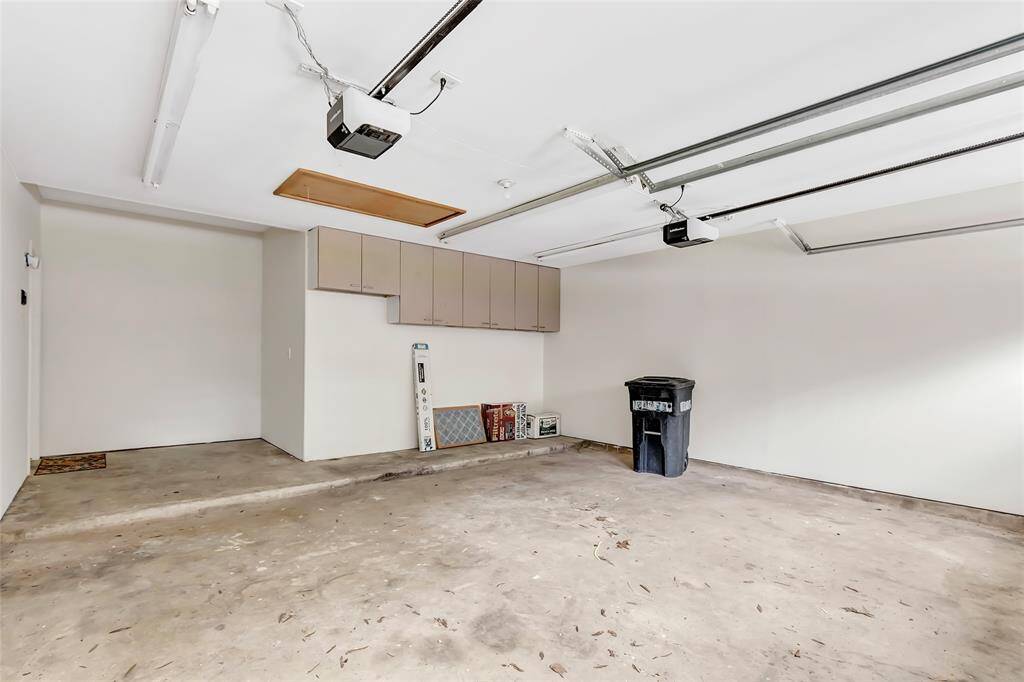 Featuring custom-built cabinets along the wall, it provides plenty of room for organizing tools, sporting equipment, or seasonal items.