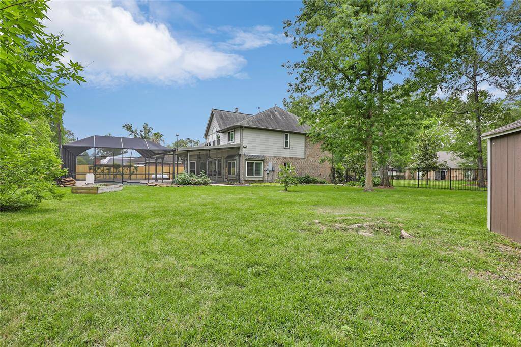 A convenient storage building provides extra space for tools, equipment, or seasonal items, helping you keep the yard organized and clutter-free. With the combination of open space and functional storage, this backyard is perfect for both relaxation and practicality.