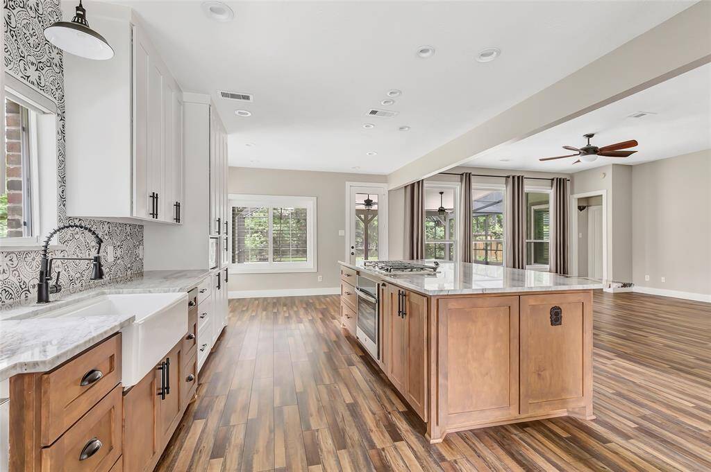 This office features custom built-in cabinetry and shelving, it offers ample storage and organization for all your work essentials.