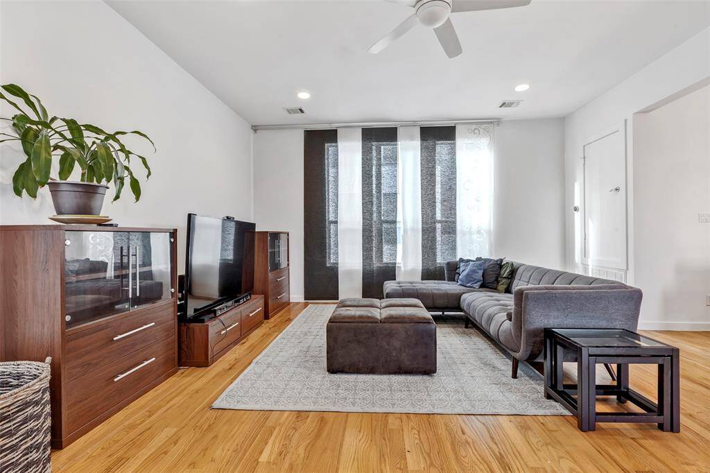 This spacious contemporarily designed living room with beautiful wood floors, is ready to be transformed into your perfect relaxation haven.