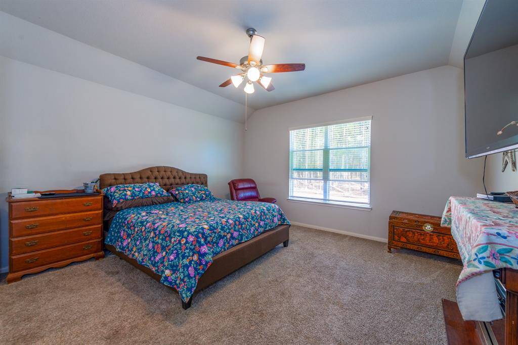 The primary owner's retreat awaits, with large windows overlooking the backyard.