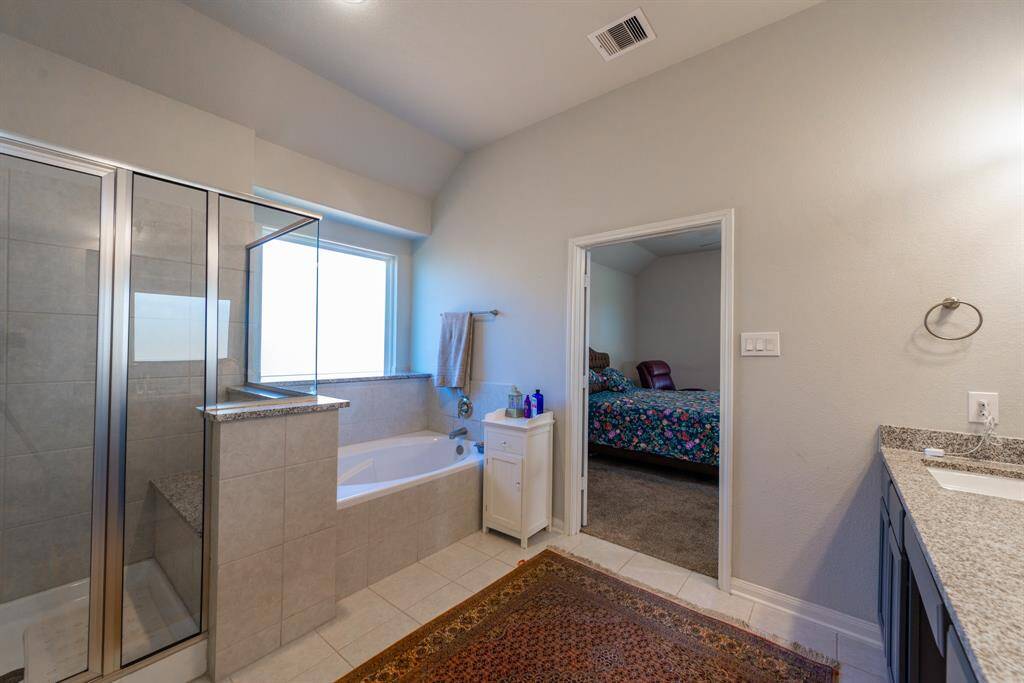The bathroom seamlessly connects to the primary bedroom, creating a private retreat.