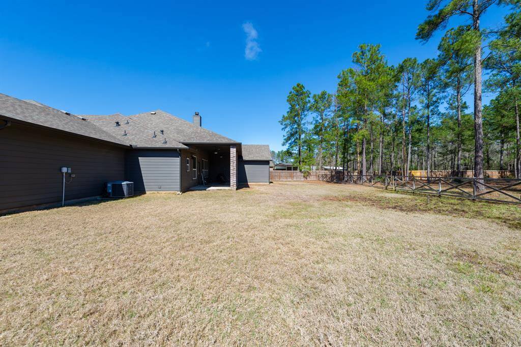 The expansive backyard offers plenty of open space and a huge covered porch, perfect for outdoor relaxation.