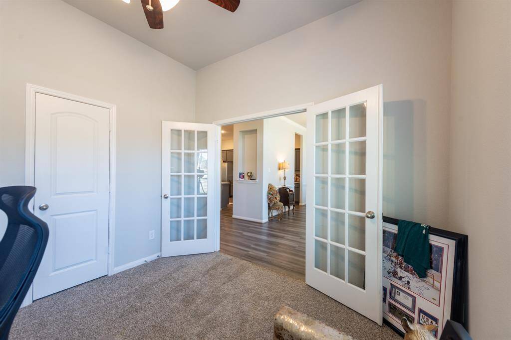 Double french doors open this flexible bedroom-turned-office to the main living area, offering both functionality and privacy.