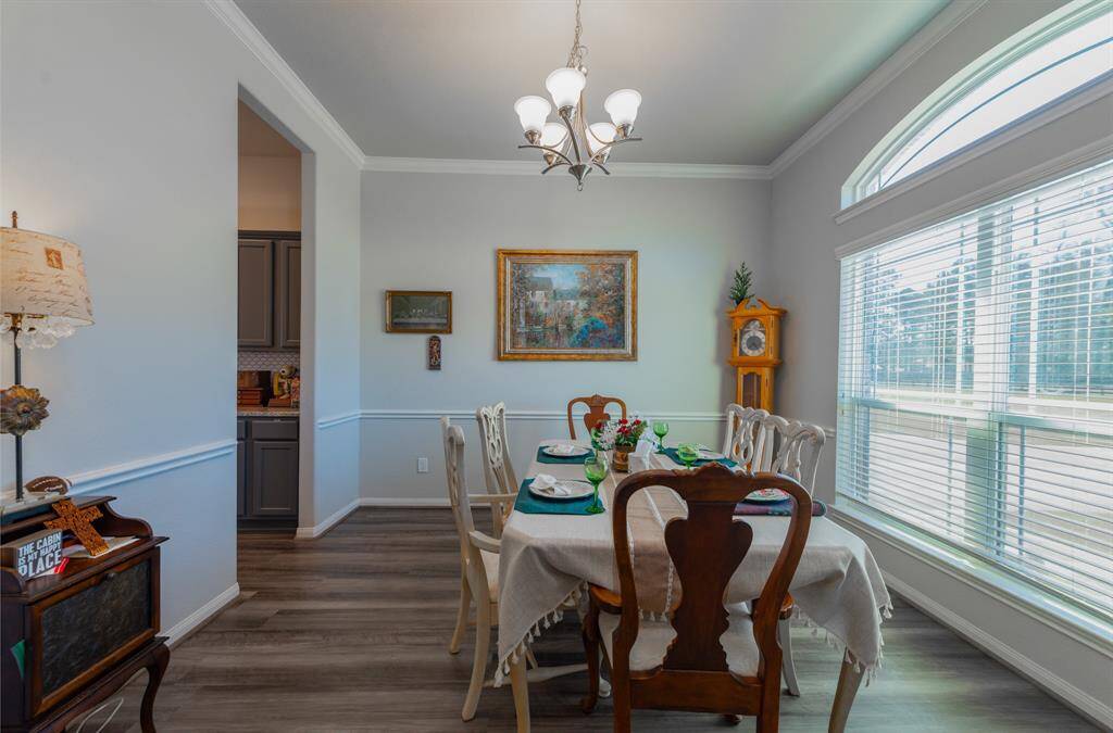 The dining room is a charming blend of natural light with oversized windows that frame the view.