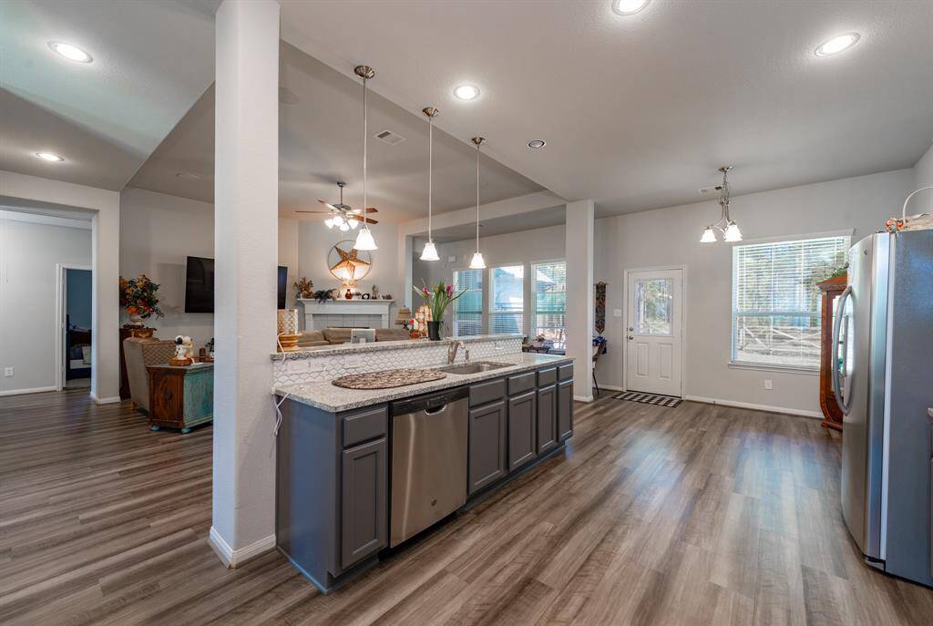 Stainless steel appliances, a stylish backsplash, and plenty of counter space make cooking effortless.