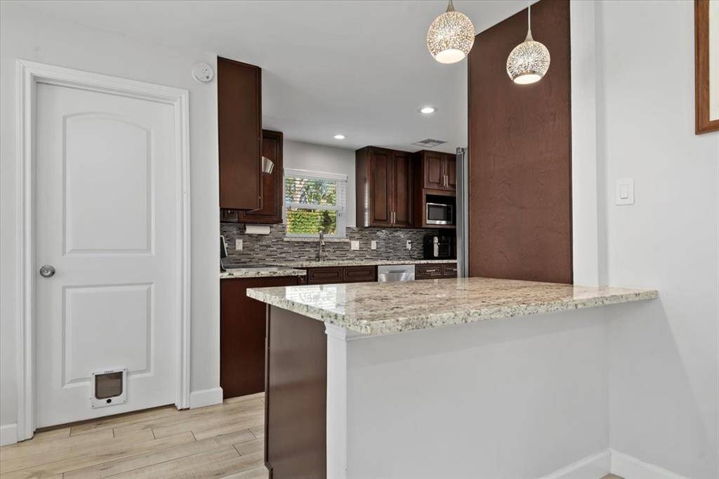 The kitchen features 42 inch wood cabinets, granite countertops and tile backsplash.