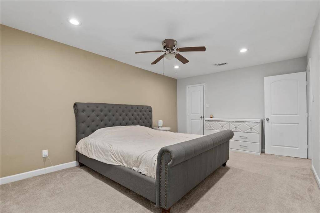 Upstairs, you have 4 bedrooms. This is the primary and easily fits a king size bed with plenty of room to spare.