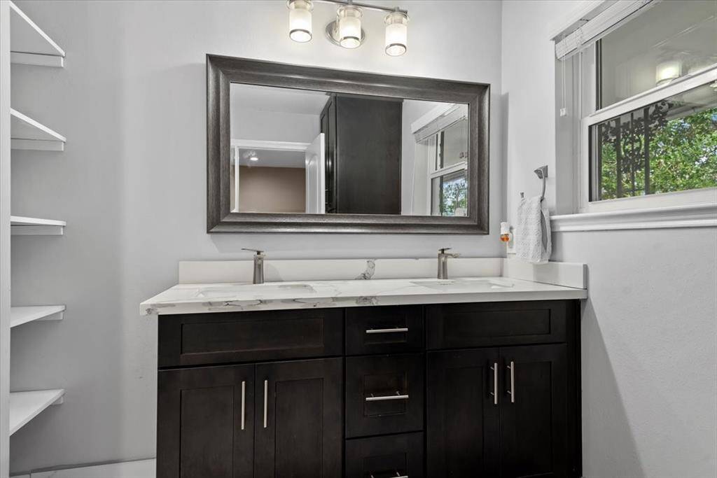 The primary bathroom has double sinks, updated vanity and tile work. The home has PEX throughout.