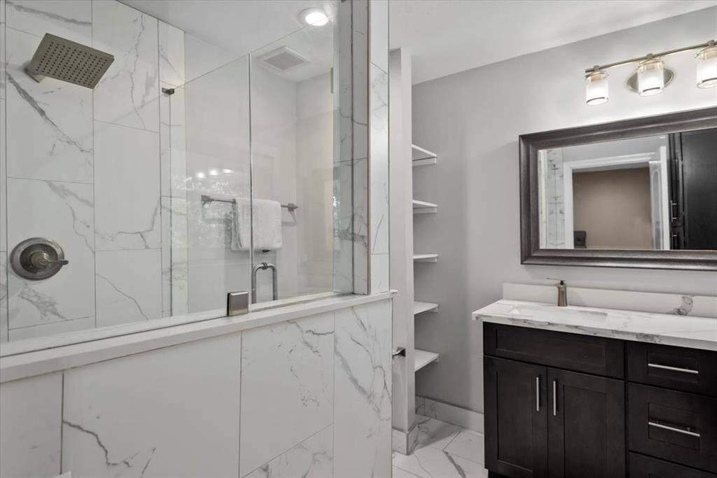 Alternate view of primary bath with built-in shelving.
