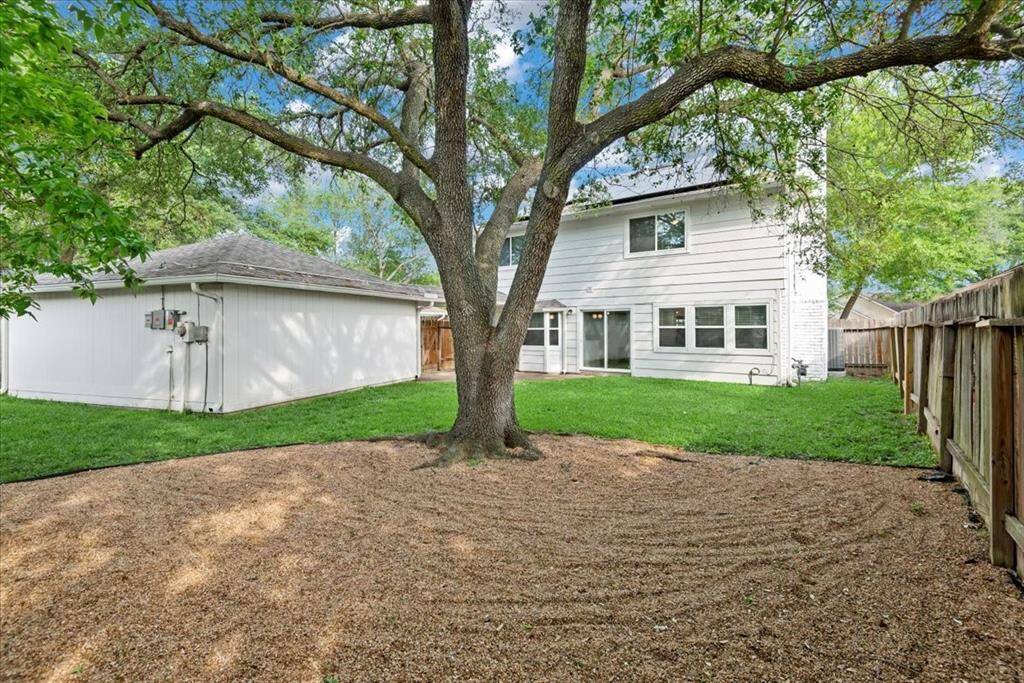 The yard is spacious with a mature tree perfect to hang a hammock or tire swing. The corner has accent gravel.