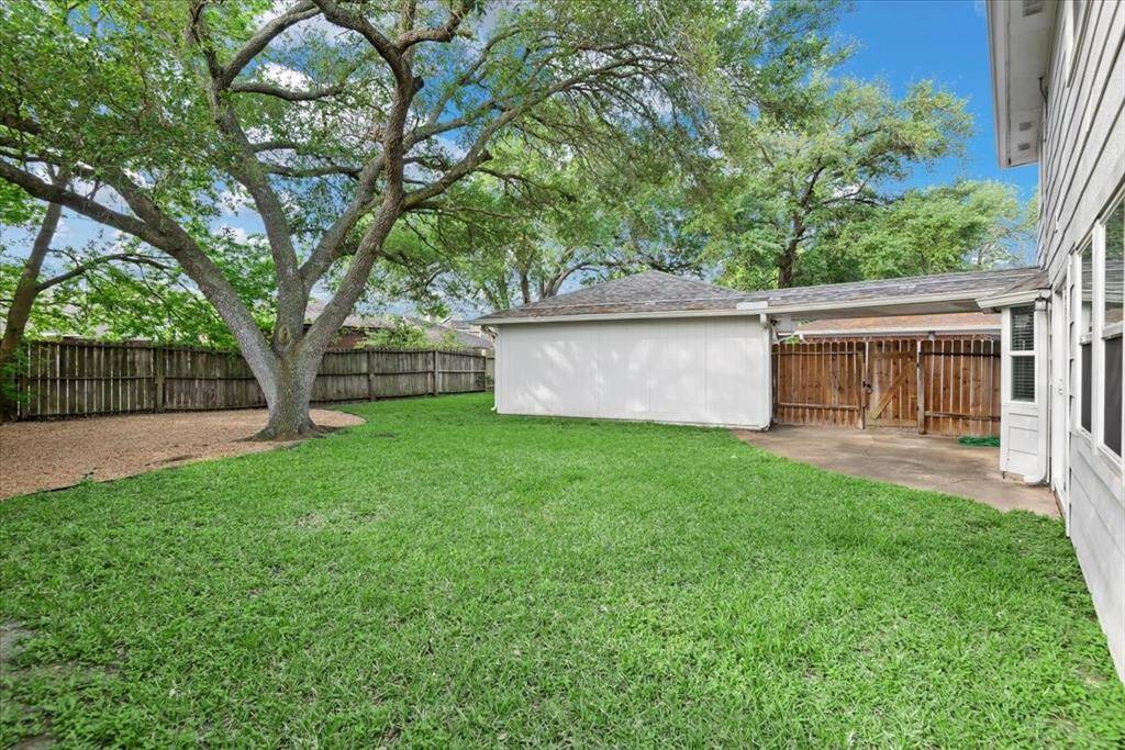 The detached 2-car garage has a covered walk-way into the home.