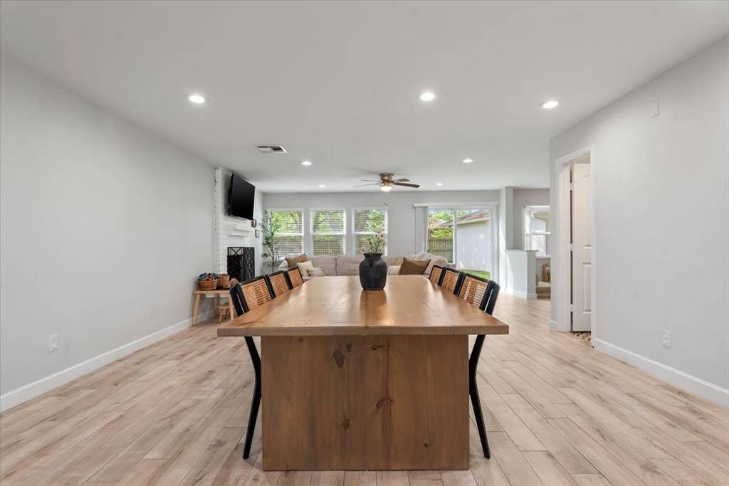 The open floor plan flows seamlessly. The first floor features neutral vinyl plank throughout.
