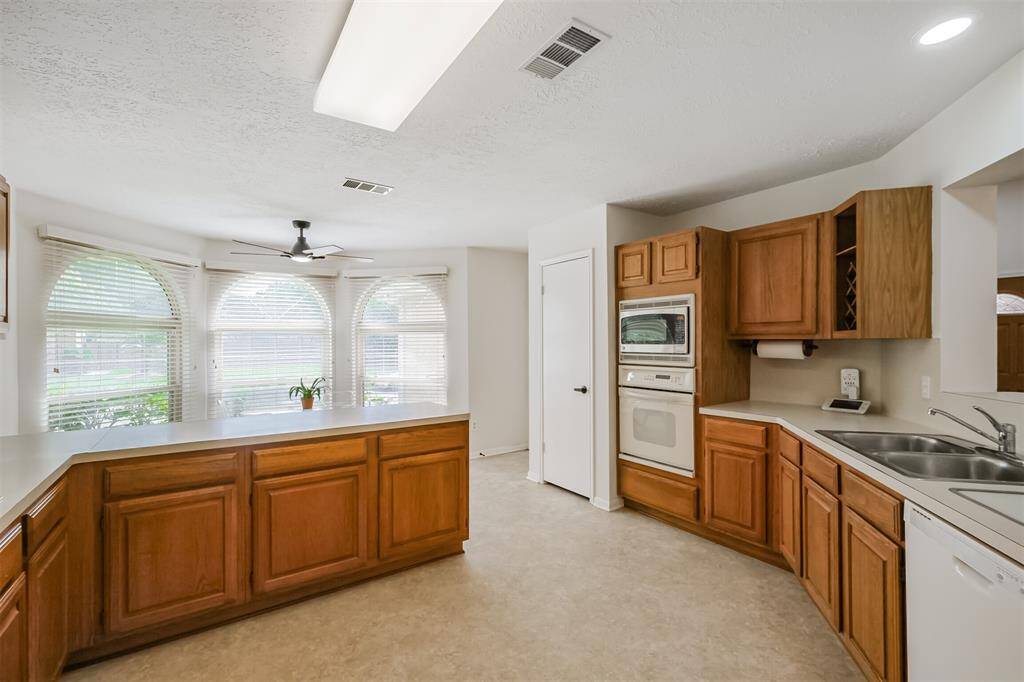 Features like the built in microwave, cutting board, wine rack, and paper towel roll create a homey atmosphere