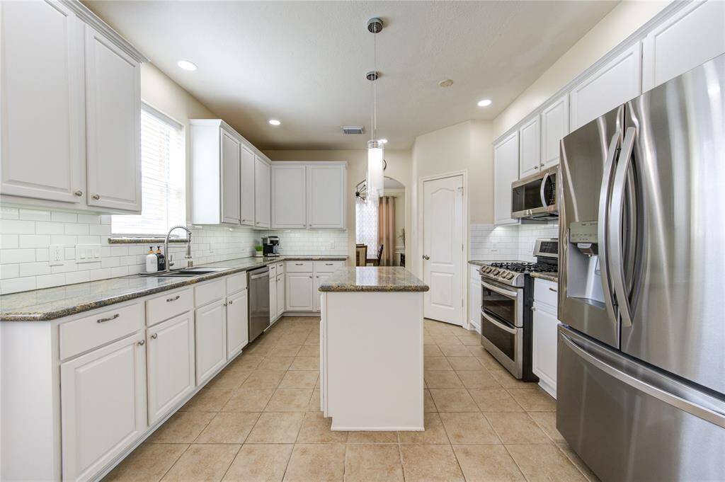 Beautiful white cabinets, back splash and granite counter tops.