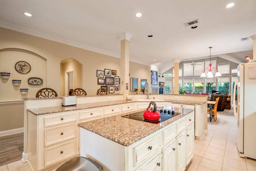 The kitchen is open to the breakfast and living room, with room for lots of extra seating around the bar.