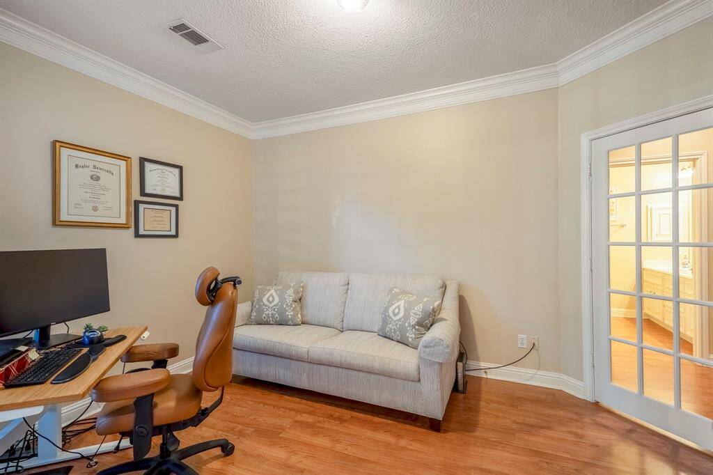 The study has crown moulding, and has 2 entrances...one to the back bedrooms, and one off the main entry. There's also a window adding light and a view.