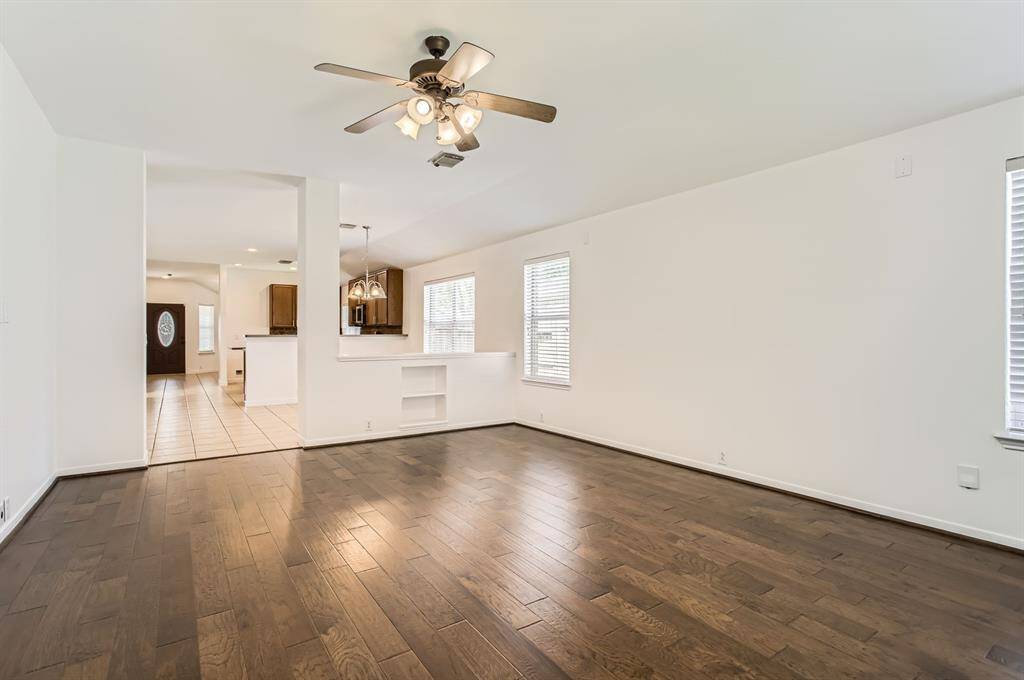 Enjoy fun with family and friends in this spacious and open Family Room featuring natural lighting and engineered hardwood flooring.