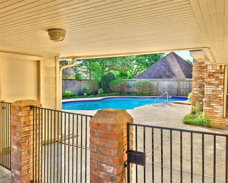 Gated Entrance to Backyard w/ Covered Patio & Walkway to Detached Garage