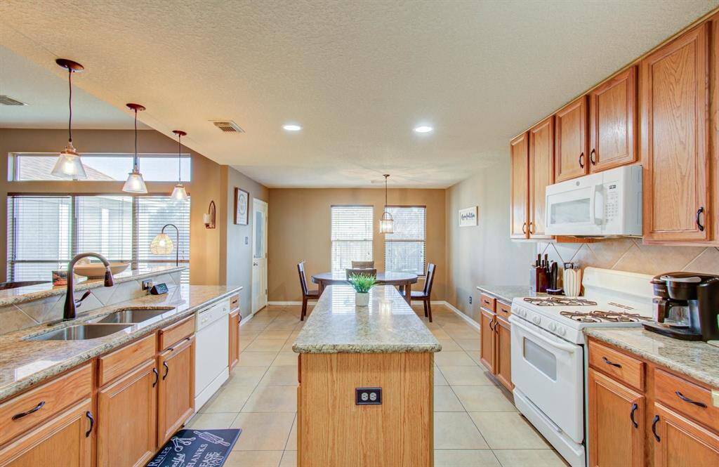 The granite island kitchen with compliment of copious amounts of counter space-surround with 42" cabinetry and upgraded hardware pulls, is just fantastic.
