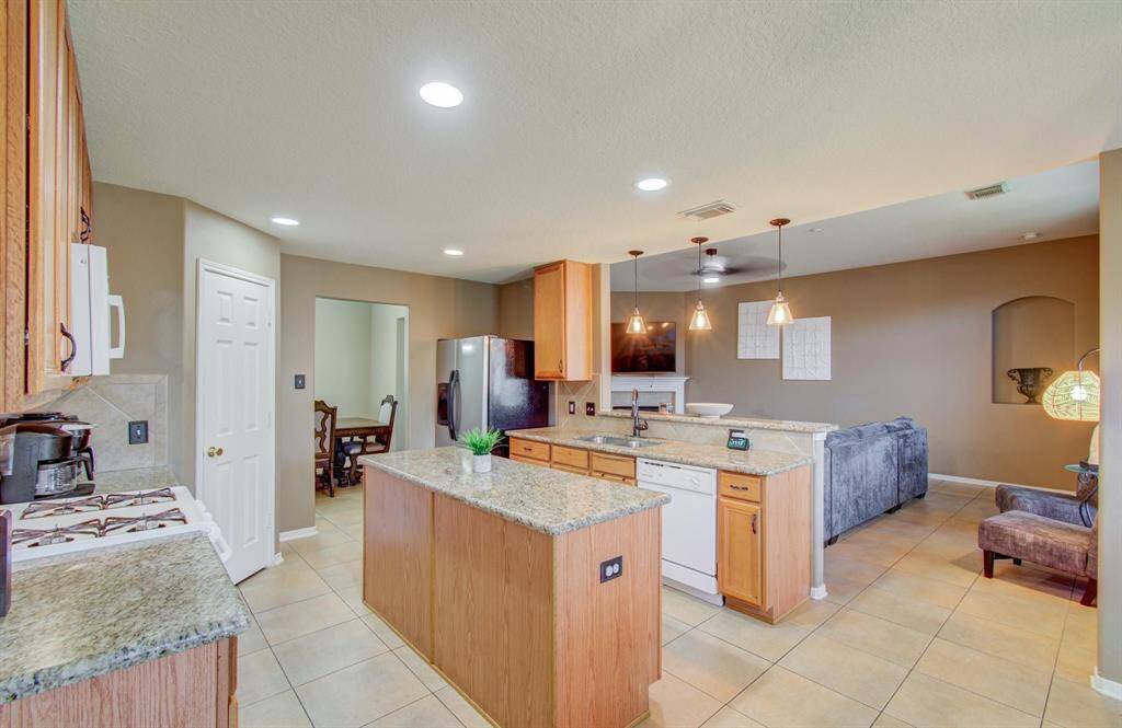 Large kitchen with Granite counter-tops, fully functional island with good amounts of extra storage and functional electrical outlet and well sized kitchen pantry.