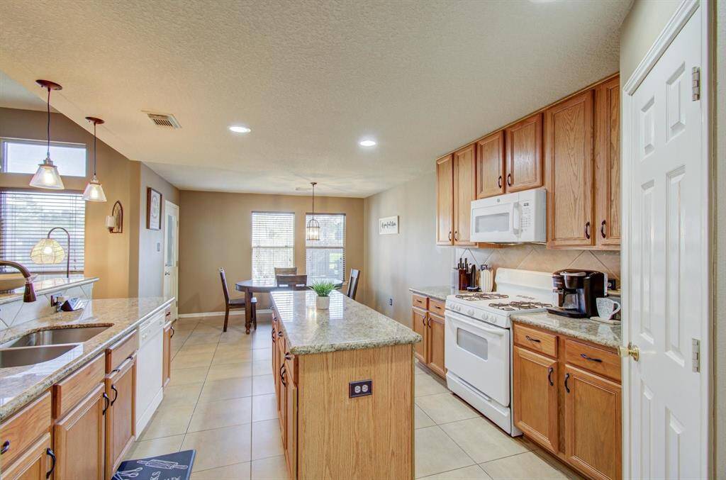 Kitchen also features real tile back splash and pendent lighting.