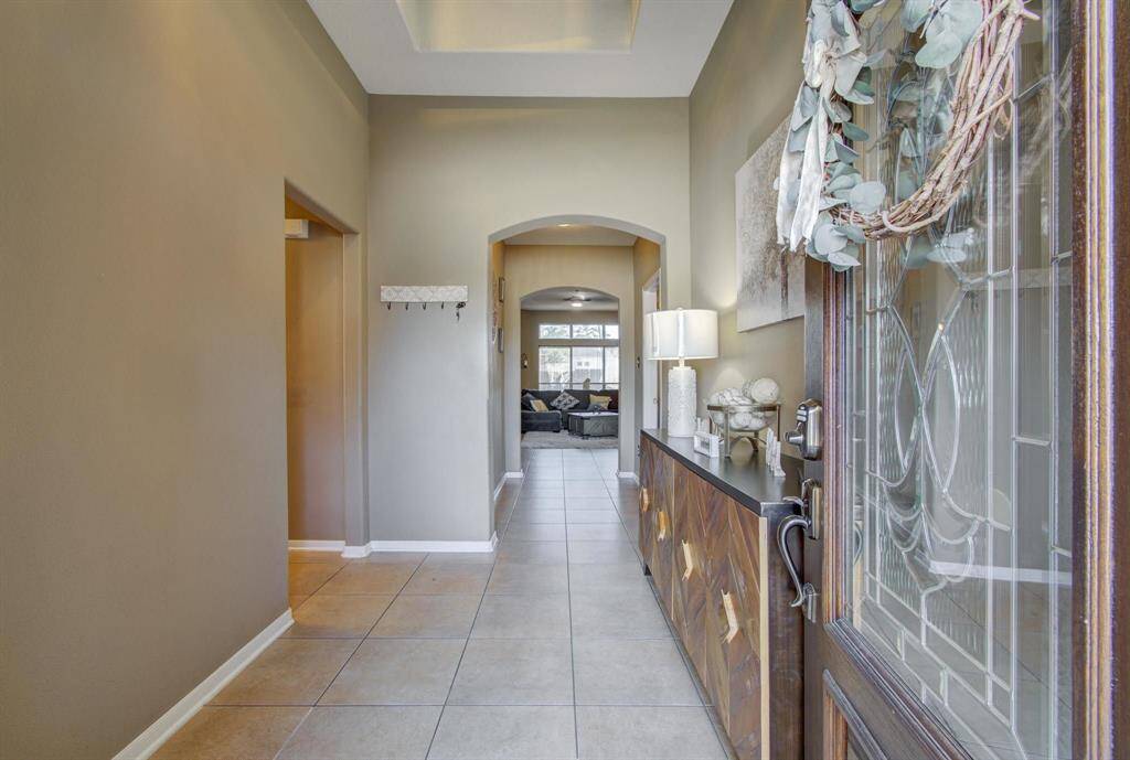 Elegant entryway with an elevated tray-ceiling, upgraded lead glass with an additional glass security door.