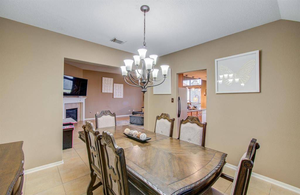 Another view of the Formal Dining area with dual outlets to kitchen and family rooms.