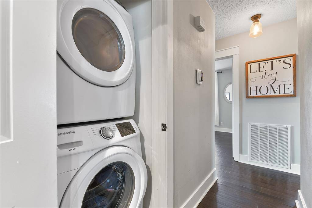 You'll enjoy this space-saving utility closet in the hallway that comes fully equipped with the Samsung stackable washer and dryer that are in place.