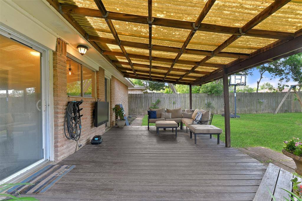 Enjoy relaxing or entertaining on this large covered patio area that's perfect for grilling and dining al fresco year round or catching a game on a breezy fall afternoon while the littles play in the large backyard.
