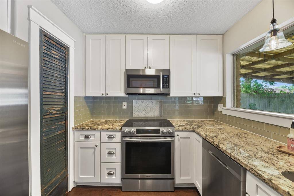 The chef of the house will undoubtedly appreciate the roomy pantry with an antique shutter door, the extra large single basin undermount sink, and the all stainless appliances that include a smooth glass cooktop, a concealed control dishwasher, and a vent hood microwave.