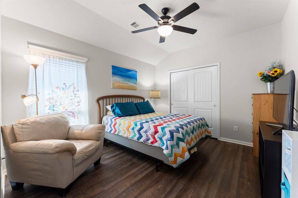 Bedroom #2 is approx 12' x 11' and has vinyl plank flooring, blinds on the windows, and a ceiling fan.