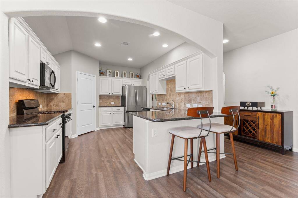 The Kitchen has bar stool seating at the edge, and good granite counter space.